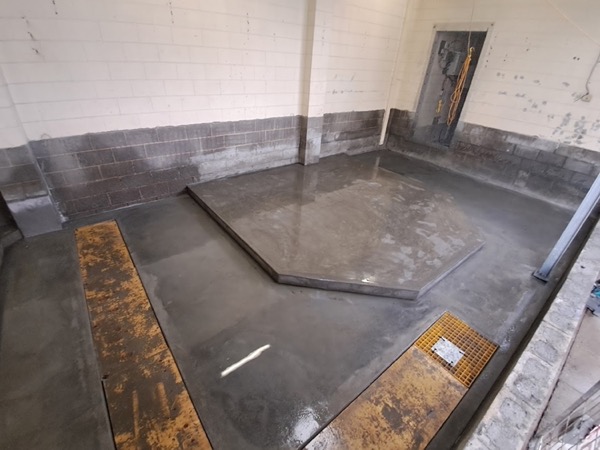 An interior blockwork room with formed concrete work set into the floor